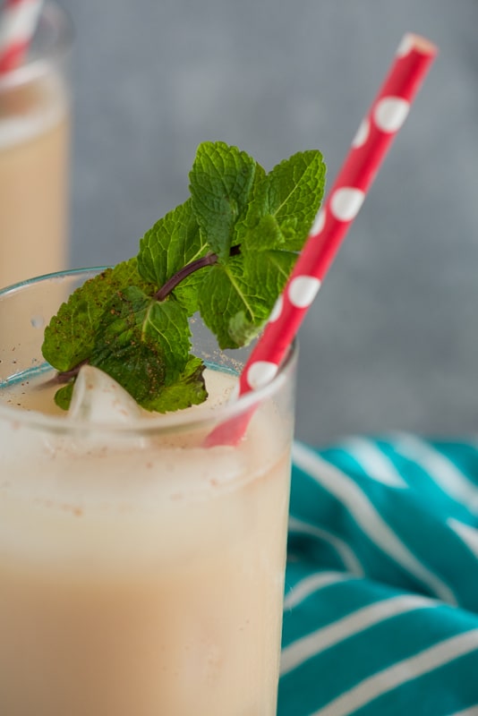thai iced tea with mint and a red straw