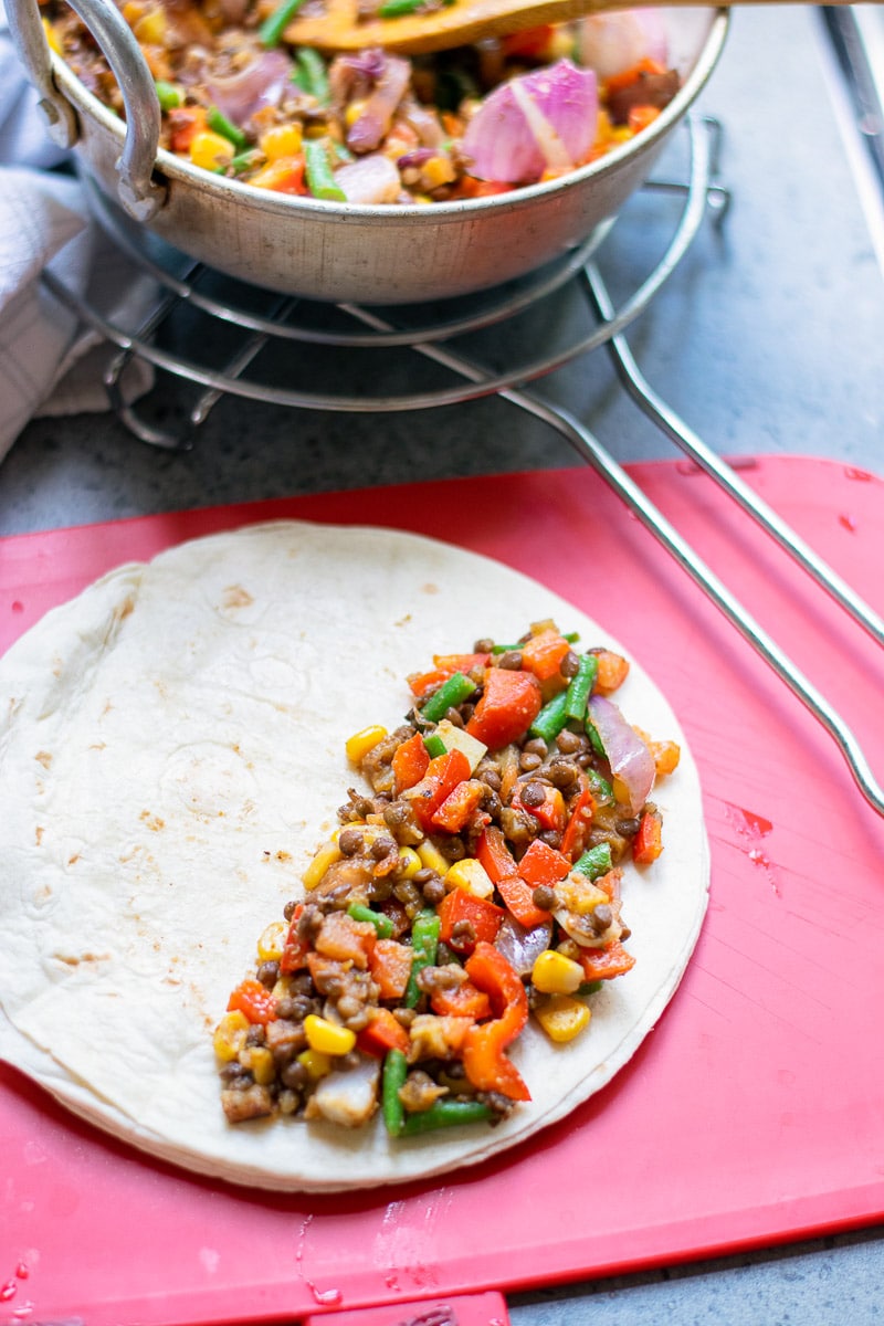 open tortilla with veggie filling on one side