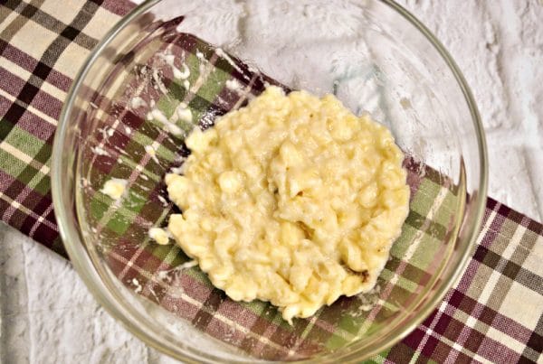 mashing banana for zucchini bread