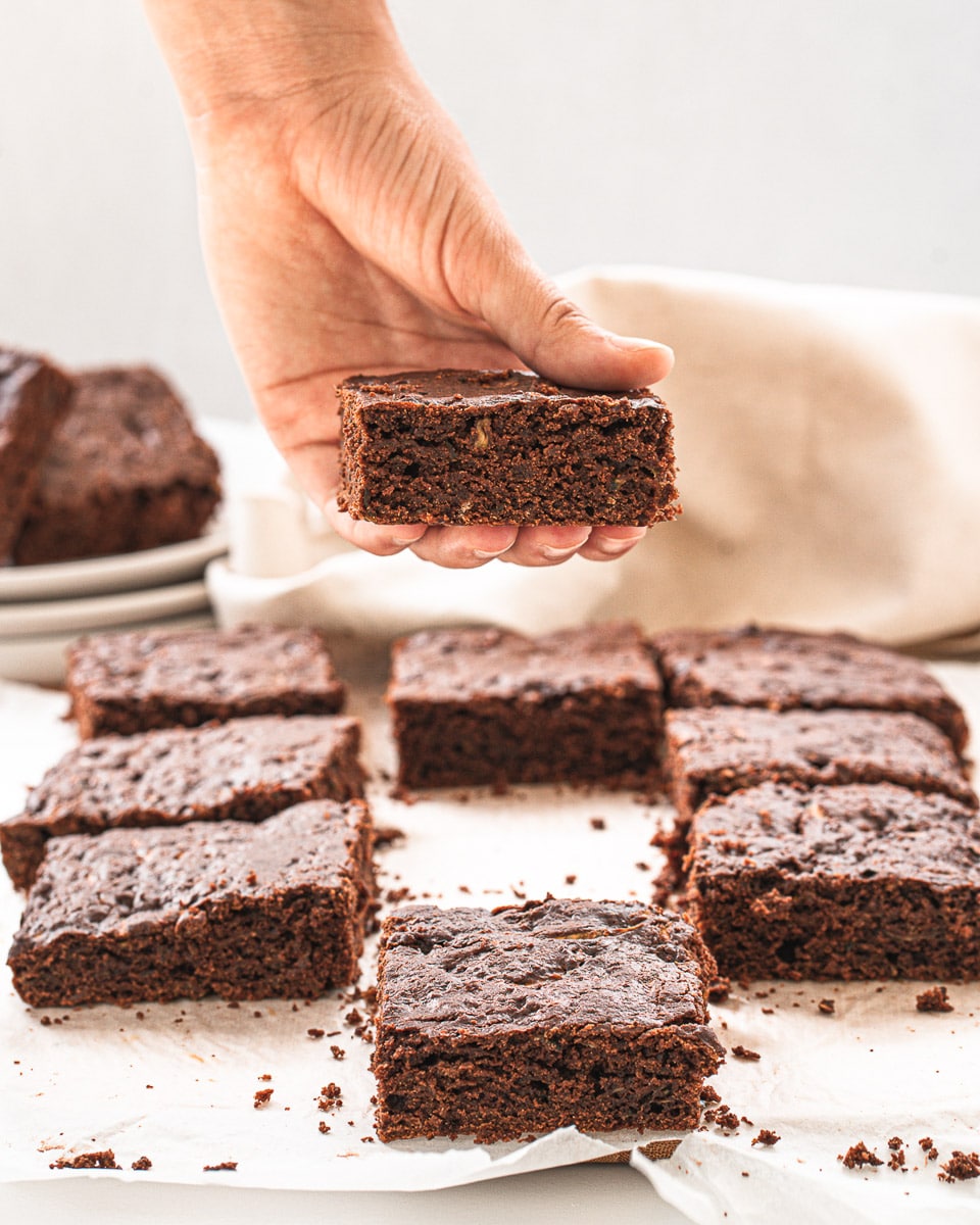 hand holding a vegan zucchini brownie