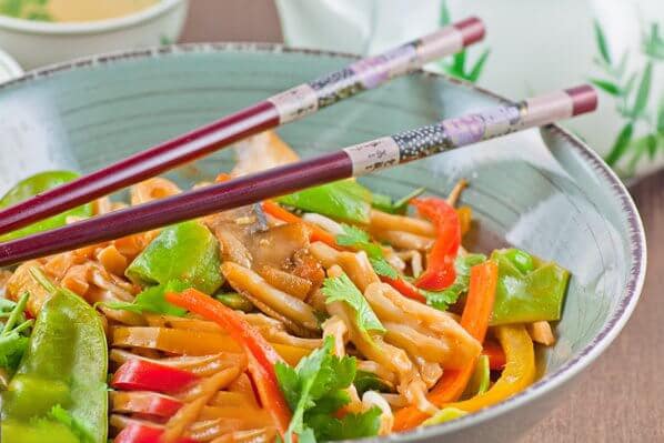 vegan udon noodle stir fry in a serving bowl