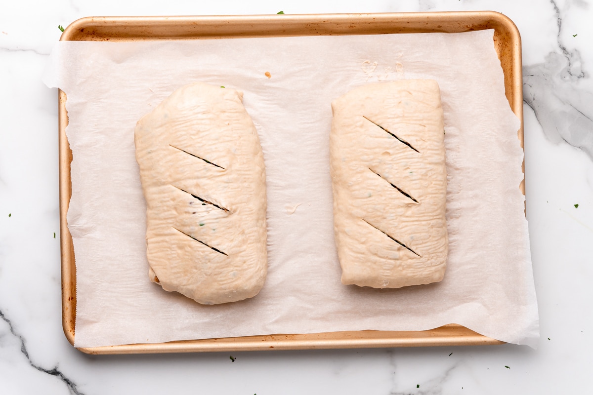 flipping the wellingtons and cutting slits before baking