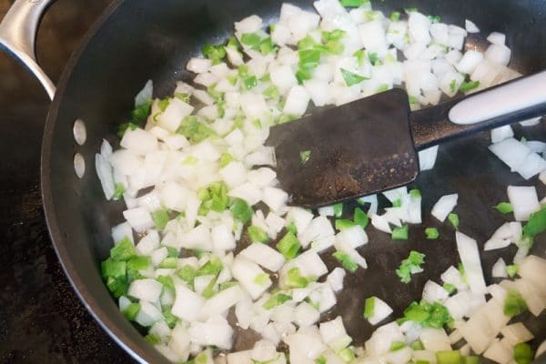 cooking onions and peppers for chili cheese dip