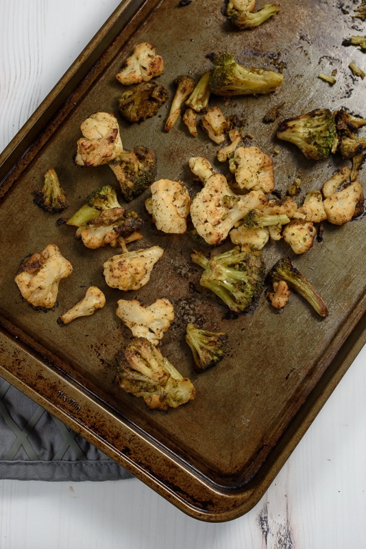 roasted broccoli and cauliflower on a baking sheet
