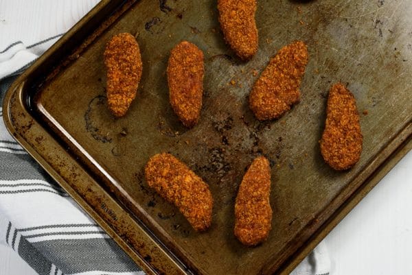 nashville hot chick'n tenders from gardein on a baking sheet