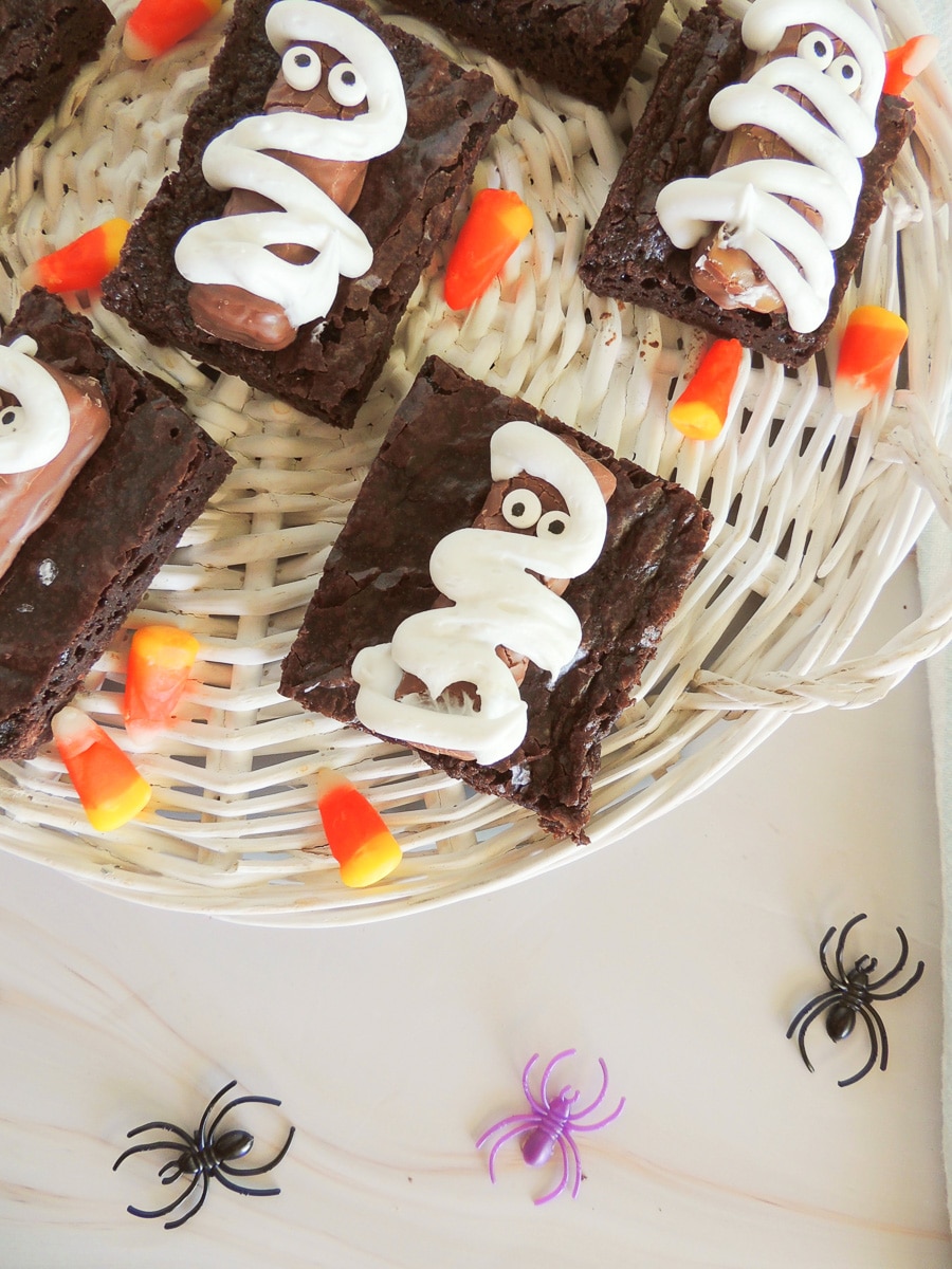 Close-up of mummy brownies with candy corn on a woven tray