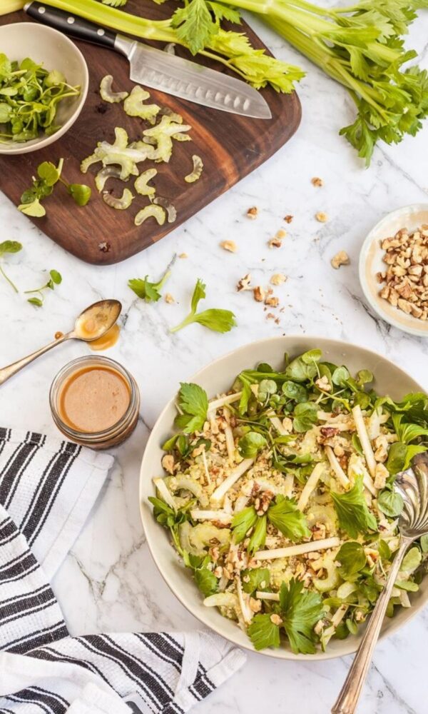 Celery apple walnut salad with honey miso dressing, ready to serve