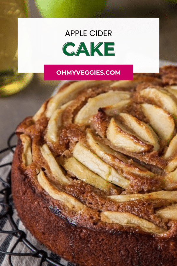 Close-up of apple cider cake with a spiral of baked apple slices, Pinterest graphic with the recipe title