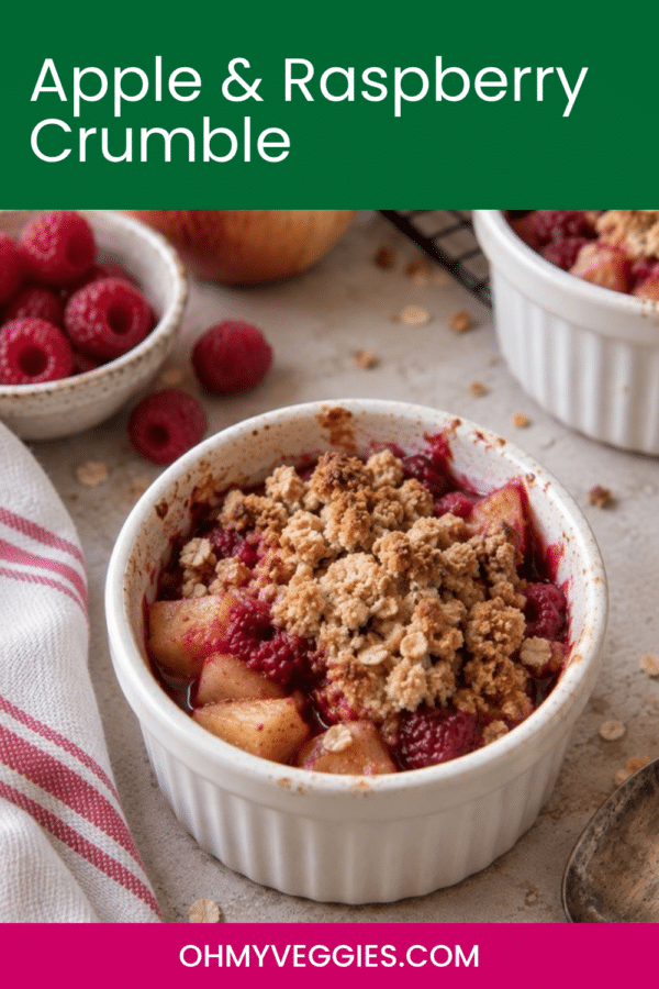 Apple and raspberry crumble recipe pin showing a baked crumble in a white ramekin