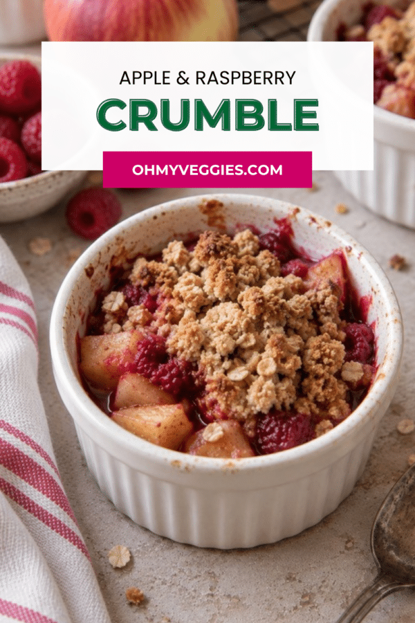 Apple and raspberry crumble in a ramekin with fresh raspberries, Pinterest graphic