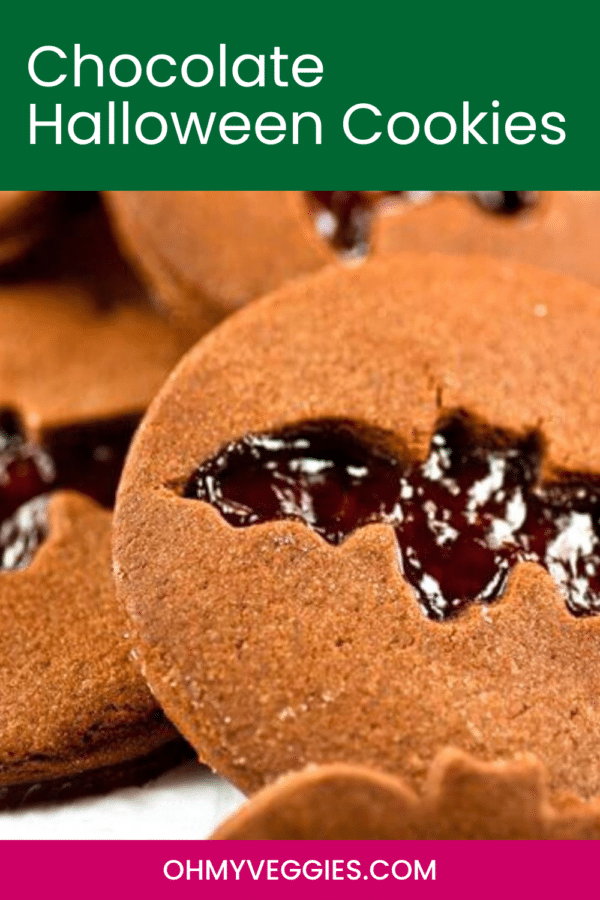 Chocolate Halloween cookies Pinterest pin showing a close-up of a bat cut-out cookie with jam