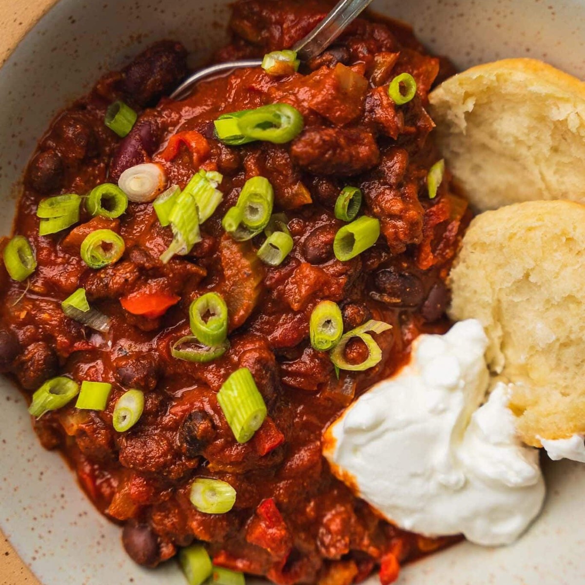 Close-up of easy vegan chili with black beans, scallions and dairy-free yogurt
