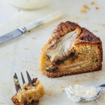 Slice of pear, chocolate and cardamom cake on parchment paper