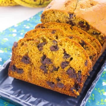 Sliced pumpkin banana chocolate chip bread on a blue platter