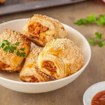 Pumpkin and harissa vegetarian sausage rolls in a white bowl