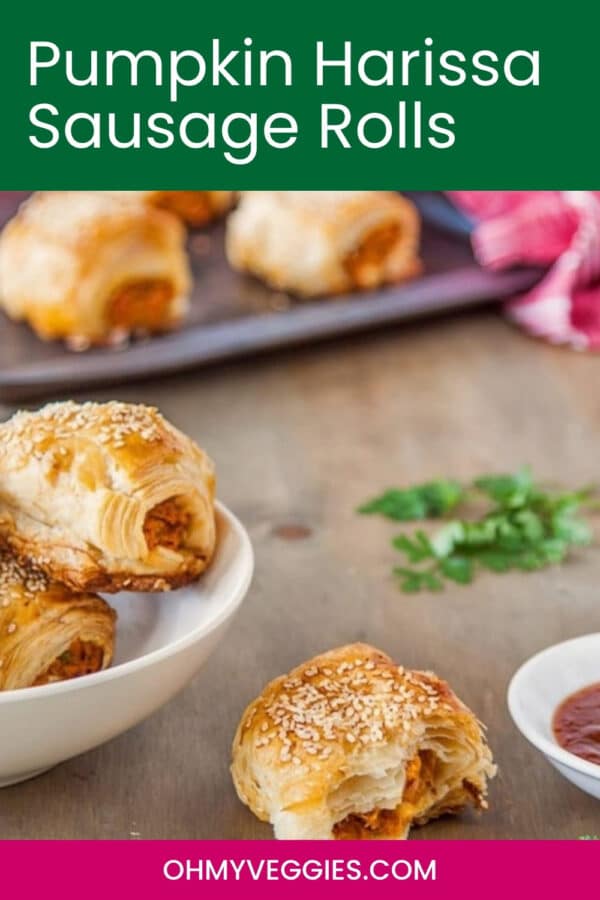 Pumpkin harissa vegetarian sausage rolls on a table with one bitten roll, Pinterest graphic