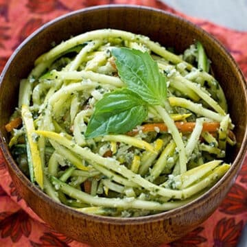 Pumpkin seed pesto tossed with zucchini and squash noodles in a wooden bowl