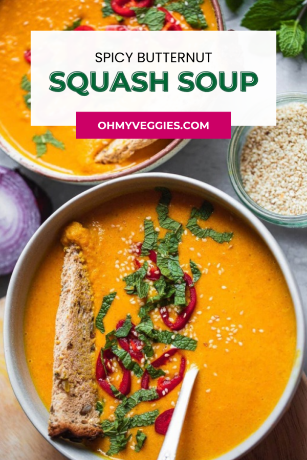 Spicy butternut squash soup Pinterest graphic with a bowl of orange soup, chili and mint