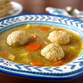 Matzo Ball Soup with Spring Vegetables in a bowl