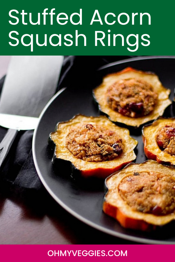 Stuffed acorn squash rings on a plate beside a spatula with the recipe title