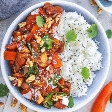 Vegan eggplant butternut squash curry with white rice in a blue bowl
