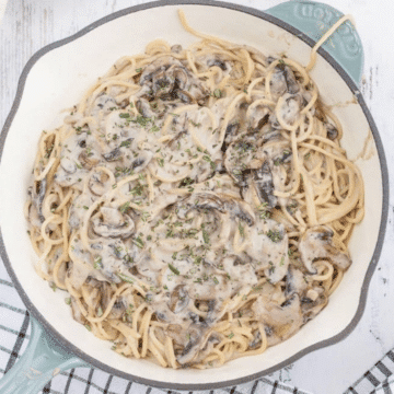 Vegan one pot creamy mushroom pasta in a light blue skillet