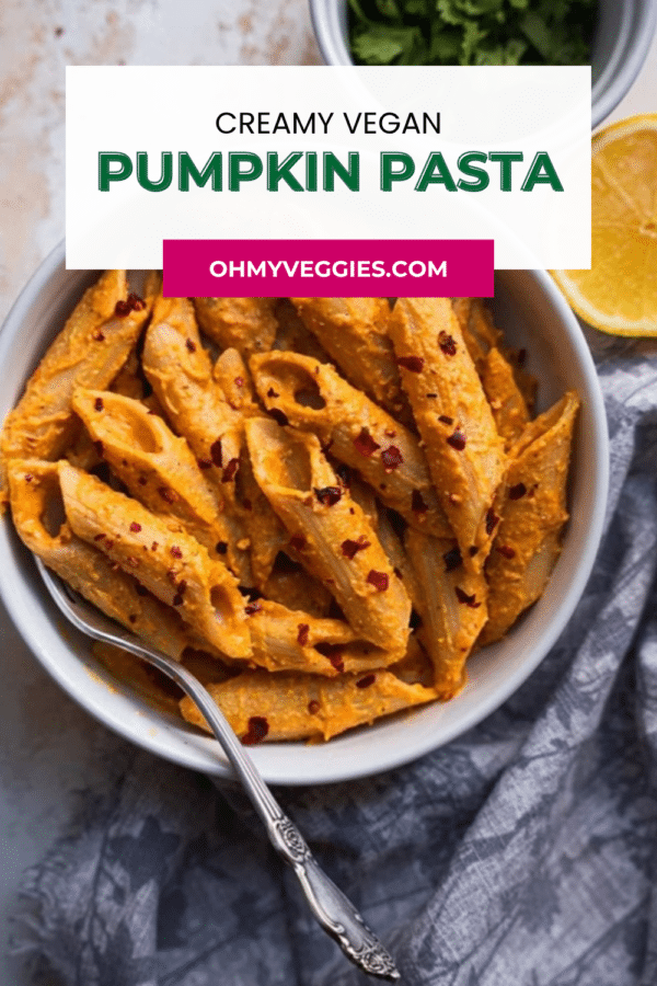 Creamy vegan pumpkin pasta Pinterest pin with a bowl of penne and lemon