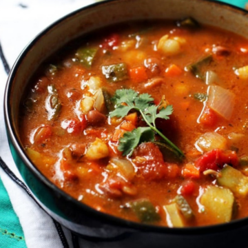 Bowl of vegetarian posole with hominy, pinto beans and poblano peppers