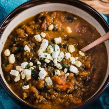 Vegetarian slow cooker pumpkin chili topped with crumbled goat cheese